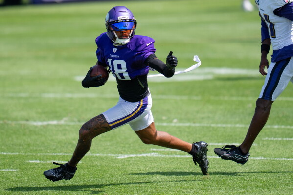 Minnesota Vikings wide receiver Justin Jefferson (18) makes a contested catch and out runs Baltimore Ravens cornerback Bilhal Kone (31) during a joint NFL football practice, Wednesday, Aug 19, 2026, in Eagan, Minn. (Alex Kormann/Minnesota Star Tribune via AP)