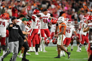 Louisville players celebrate beating Miami in an NCAA college football game, Oct. 17, 2025, in Miami Gardens, Fla. (AP Photo/Michael Laughlin, File)