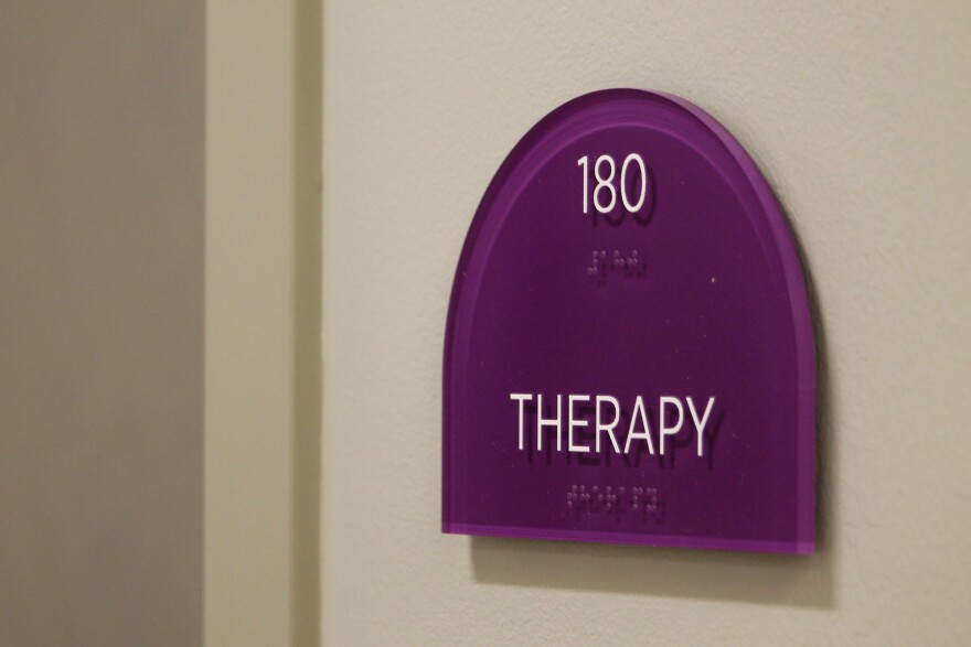 A purple sign reads "Therapy" in white block lettering.