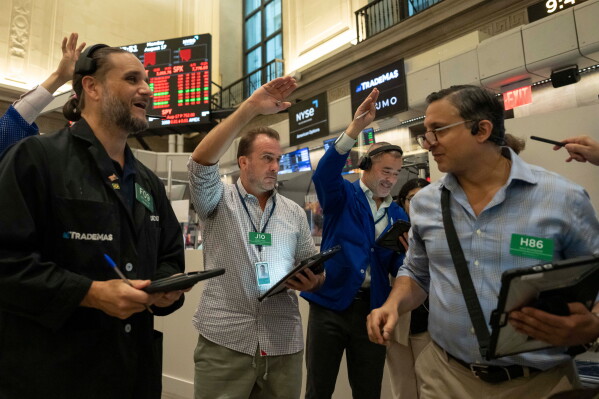 Options traders Chris Dattolo, Scott Frinzi, Justin Kanda, and Ravi Bhandari, left to right, work on the floor of the New York Stock Exchange, Monday, Aug. 17, 2026, in New York. (AP Photo/Yuki Iwamura)