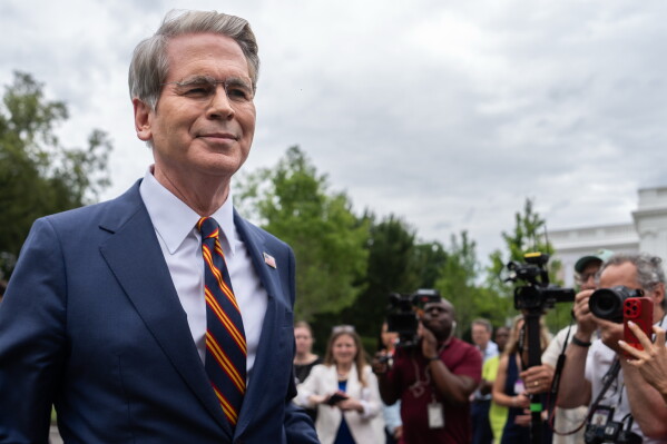 Treasury Secretary Scott Bessent walks past reporters following an interview with Fox News outside the White House, Thursday, July 30, 2026, in Washington. (AP Photo/Julia Demaree Nikhinson)