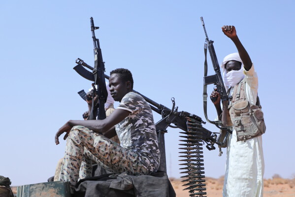 Fighters of armed defectors from the paramilitary Rapid Support Forces (RSF) celebrate, as they are believed to be surrendering to the Sudanese army, in the west of Omdurman, just outside Khartoum, Sudan, Wednesday, Aug. 19, 2026. (AP Photo/Mohnd Blal)