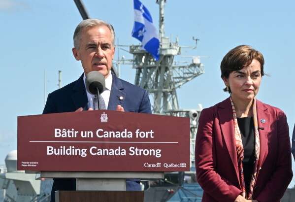 Canadian Prime Minister Mark Carney speaks as he announces a $11.3 billion contract for icebreakers at the Davie shipyard in Levis, Quebec on Monday, Aug. 24, 2026. Quebec Premier Christine Frechette, right, looks on. (Jacques Boissinot/The Canadian Press via AP)
