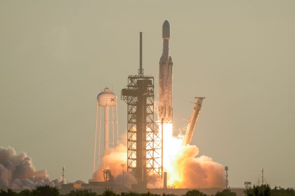 A SpaceX Falcon Heavy rocket with the space observatory Roman Telescope lifts off from launch complex 39A at the Kennedy Space Center in Cape Canaveral, Fla., Sunday, Aug. 30, 2026. (AP Photo/John Raoux)