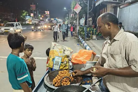 NurPhoto via Getty Image Digital payment firm Paytm's QR codes are displayed at a street food vendor in Kolkata, India, on September 13, 2025.