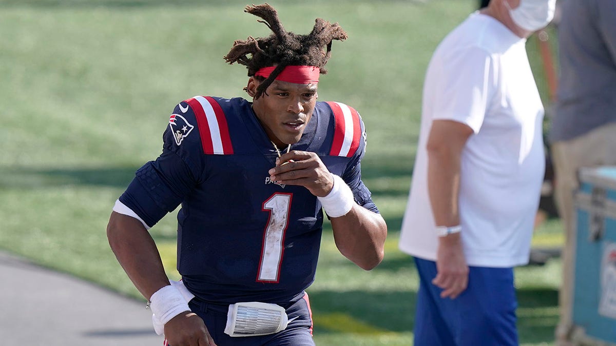 FILE — New England Patriots quarterback Cam Newton leaves the field after an NFL football game against the Miami Dolphins, in this Sunday, Sept. 13, 2020, file photo, in Foxborough, Mass. The Patriots released quarterback Cam Newton on Tuesday, Aug. 31, 2021, clearing the way for rookie Mac Jones to open the season as New England's quarterback, according to a person with knowledge of the move. The person spoke to the Associated Press on condition of anonymity because the decision has not been announced. (AP Photo/Steven Senne, File)