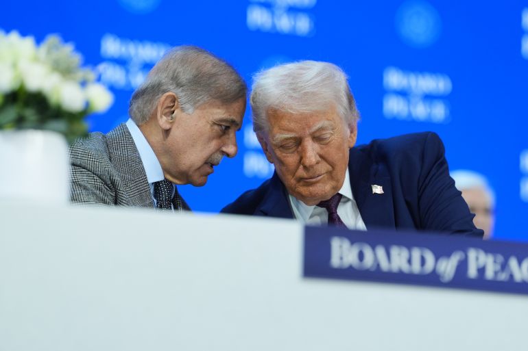 President Donald Trump, right, speaks with Mian Muhammad Shehbaz Sharif, Prime Minister of Pakistan, during a signing of the Board of Peace charter during the Annual Meeting of the World Economic Forum in Davos, Switzerland, Thursday, Jan. 22, 2026. (AP Photo/Evan Vucci)