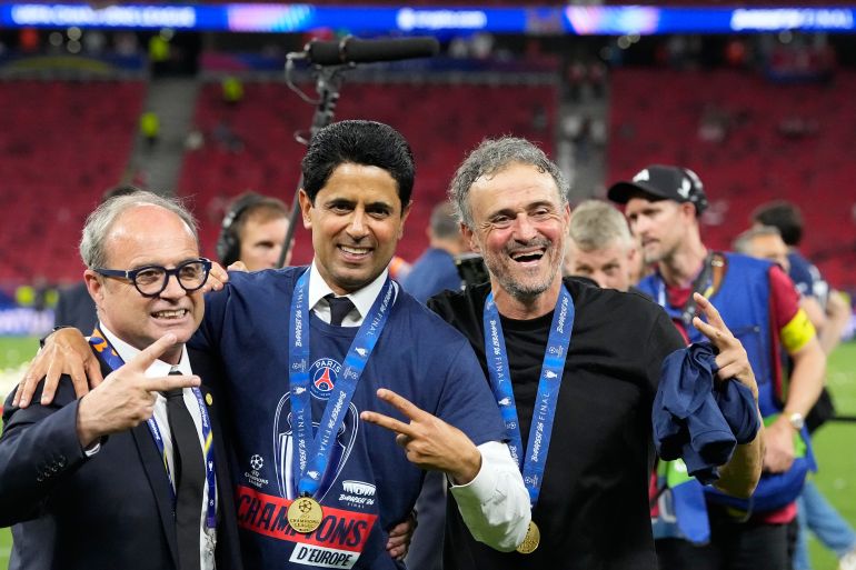 PSG's head coach Luis Enrique, from right, club President Nasser bin Ghanim Al-Khelaifi and sports director Luis Campos pose after winning the Champions League final soccer match between Paris Saint-Germain and Arsenal