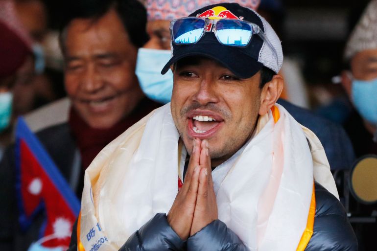 A file photo of Nirmal Purja, one of the team member of the all-Nepalese mountaineering team that became the first to scale Mount K2 in winter, gestures as the team arrives at Tribhuwan International airport in Kathmandu, Nepal on Jan. 26, 2021. [Niranjan Shrestha/AP Photo]