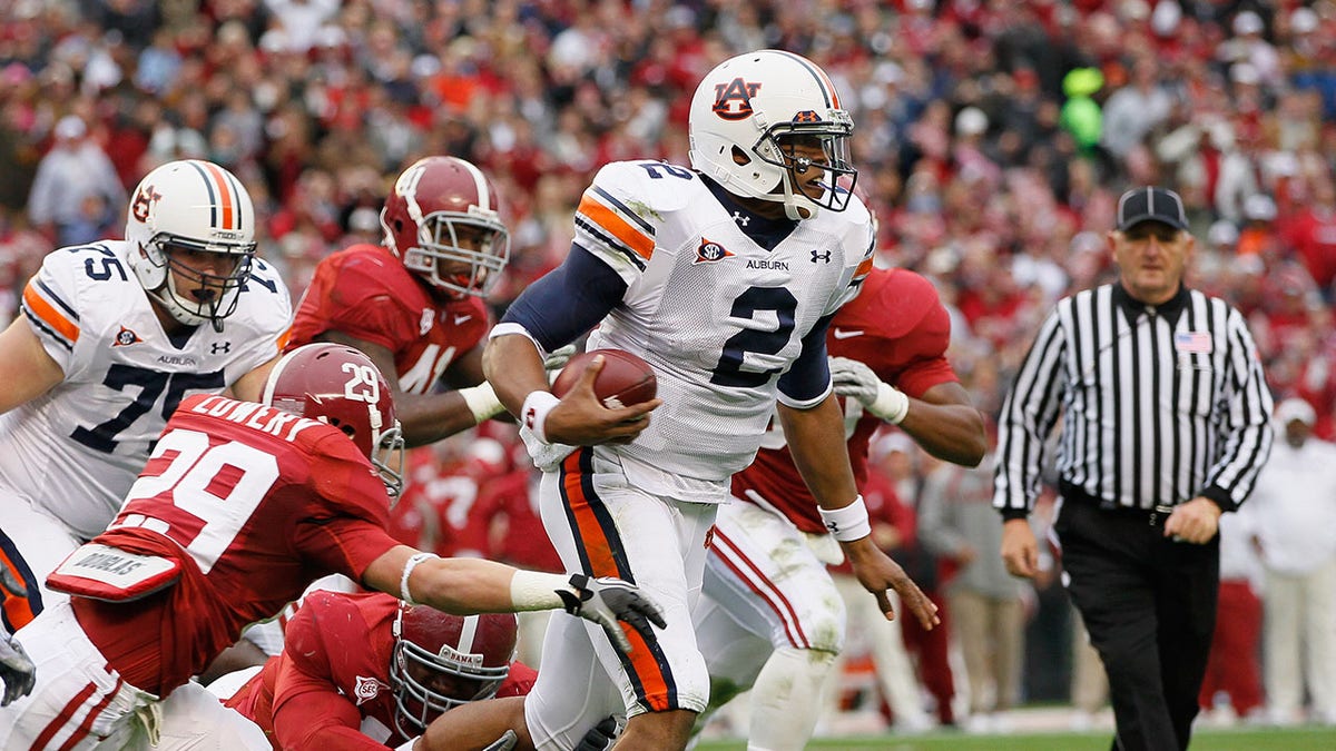Cam Newton rushes with the football