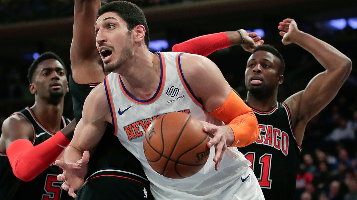 FILE - In this March 19, 2018, file photo, New York Knicks center Enes Kanter (00) drives to the basket against the Chicago Bulls during the first quarter of an NBA basketball game in New York. Kanter informed the Knicks on Friday, June 29, 2018, that he was opting into his contract for next season, rather than becoming a free agent. (AP Photo/Julie Jacobson, File)