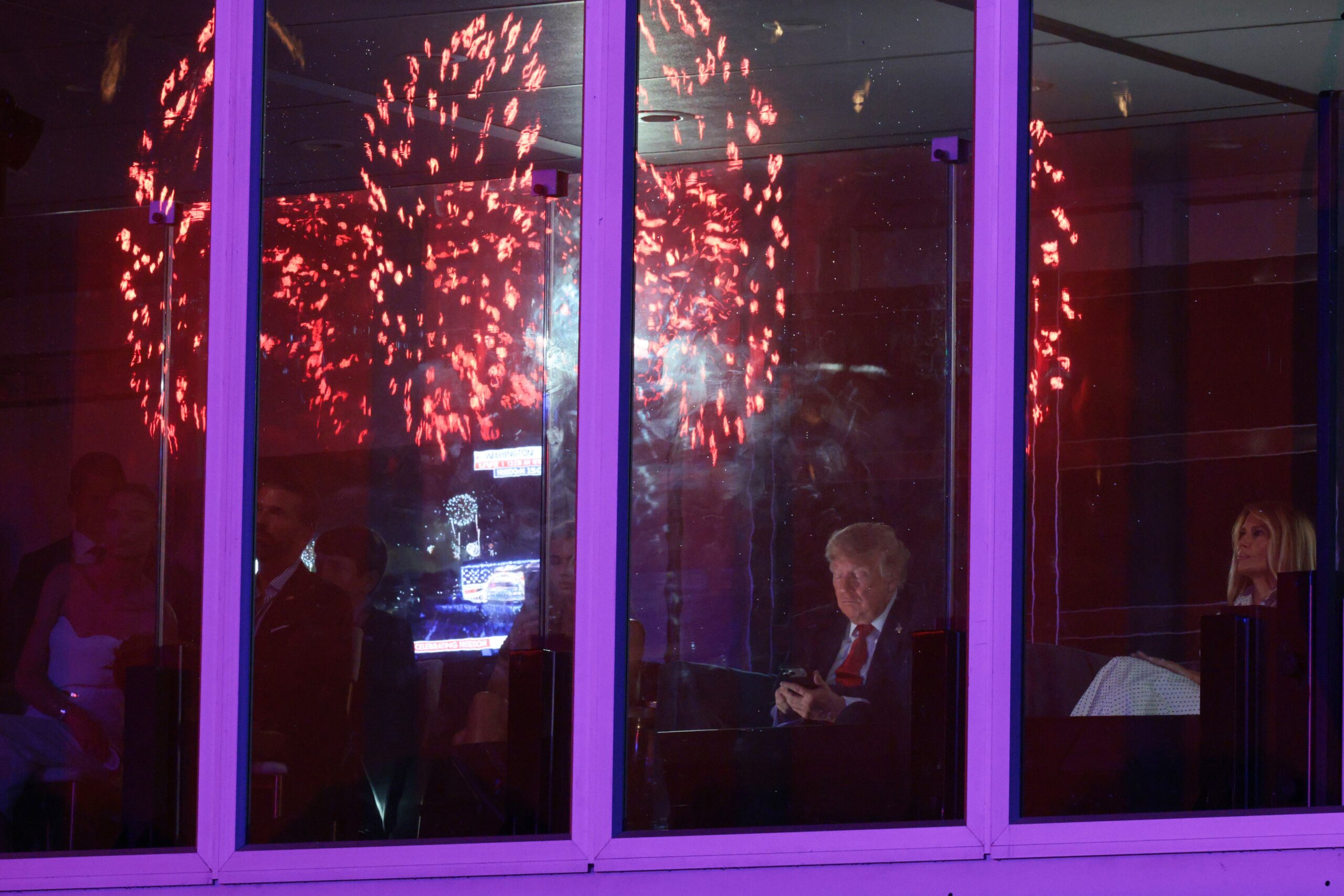President Donald Trump and members of his family sit in a viewing area during the ‘Salute to America 250’ fireworks show in the nation’s capital