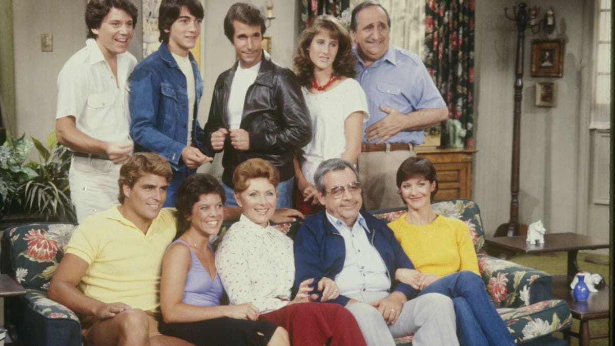 The cast of "Happy Days" posing for a photo on set.
