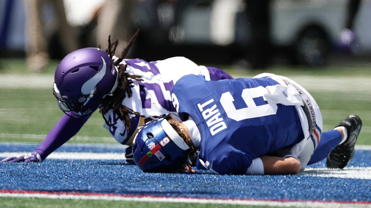 Jaxson Dart is sacked by Jay Ward during a preseason NFL game.