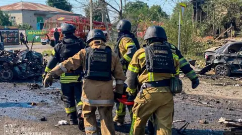DSNS Ukraine Rescuers carry a person killed during Russian drone strikes in the town of Pechenihy, amid Russia's attack on Ukraine in Kharkiv region, Ukraine August 18, 2026