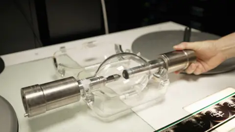 A huge lightbulb with silver handles either side