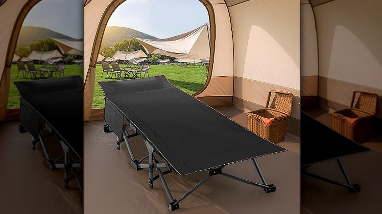 Camping cot placed open inside a tent.