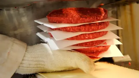 AFP via Getty Images Burger patties being made at a meatpacking business in Colorado