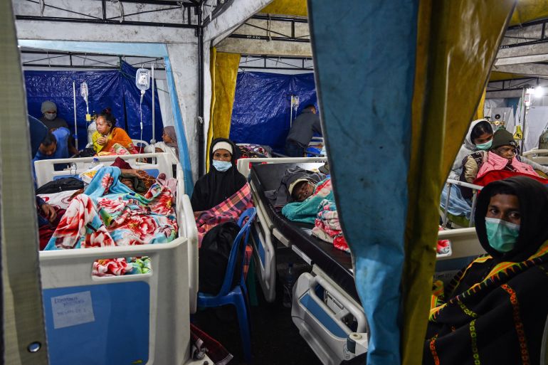 TOPSHOT - Earthquake victims are treated in a temporary medical tent due to fears of aftershocks, in front of the Ruteng hospital in Ruteng, Manggarai, East Nusa Tenggara on August 15, 2026.
