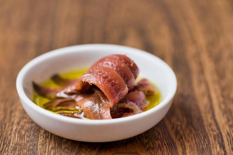 Small bowl of anchovies in oil