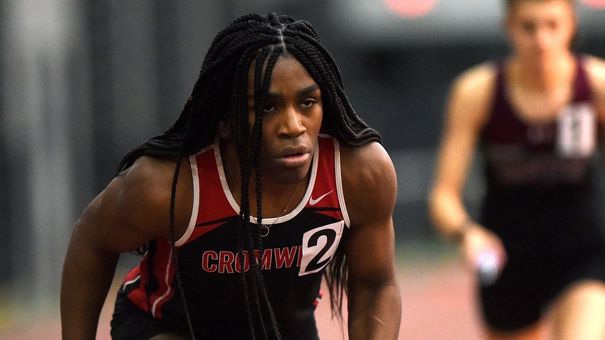 Andraya Yearwood awaits the start of the girls 4x400 relay at an indoor track championship.