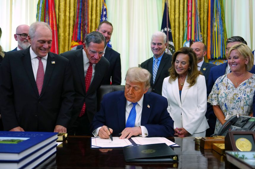President Donald Trump signs a bill funding immigration enforcement in the Oval Office of the White House, Wednesday, June 10.