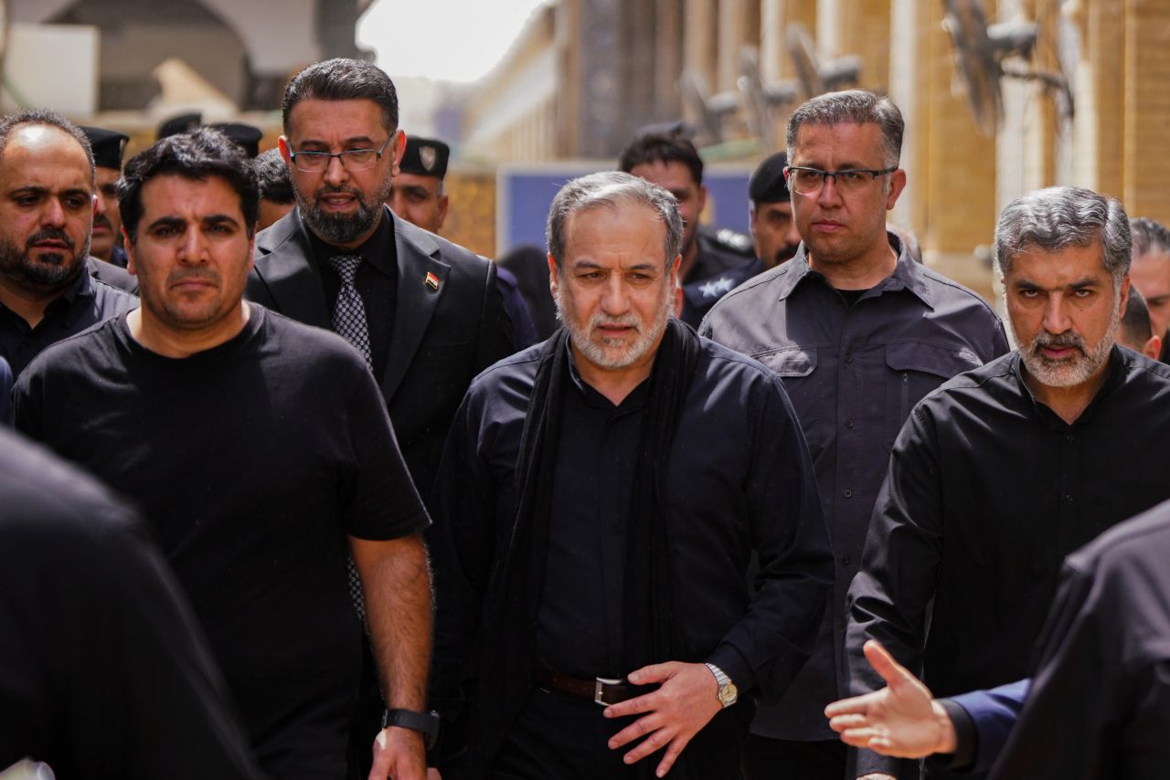 Iranian Foreign Minister Abbas Araghchi, center, is surrounded by security personnel as he walks during the Arbaeen commemoration in Najaf, Iraq, on August 3.