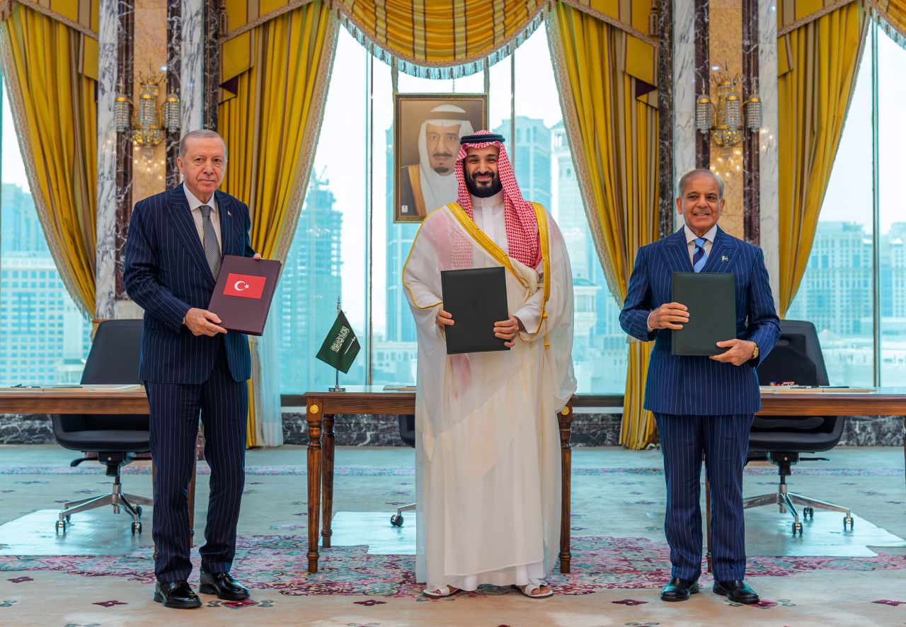 Turkish President Recep Tayyip Erdogan, Saudi Crown Prince Mohammed bin Salman and Pakistani Prime Minister Shehbaz Sharif pose after signing a trilateral defense agreement in Mecca, Saudi Arabia, on Friday.