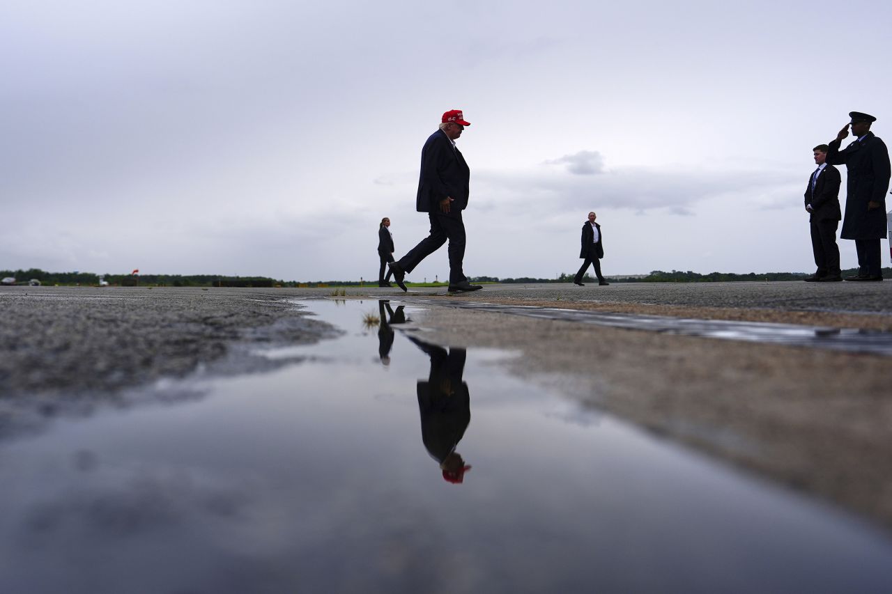 President Donald Trump walks to board boards Air Force One at Morristown Airport, on Sunday.