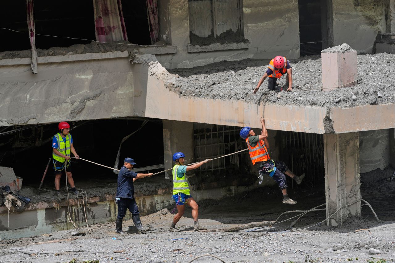 Rescuers search for bodies following flash floods in Nepal's Nuwakot district on Saturday.