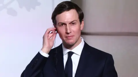 Getty Images Close up of Jared Kushner, who has short, dark hair and is wearing a dark suit, white shirt and tie.