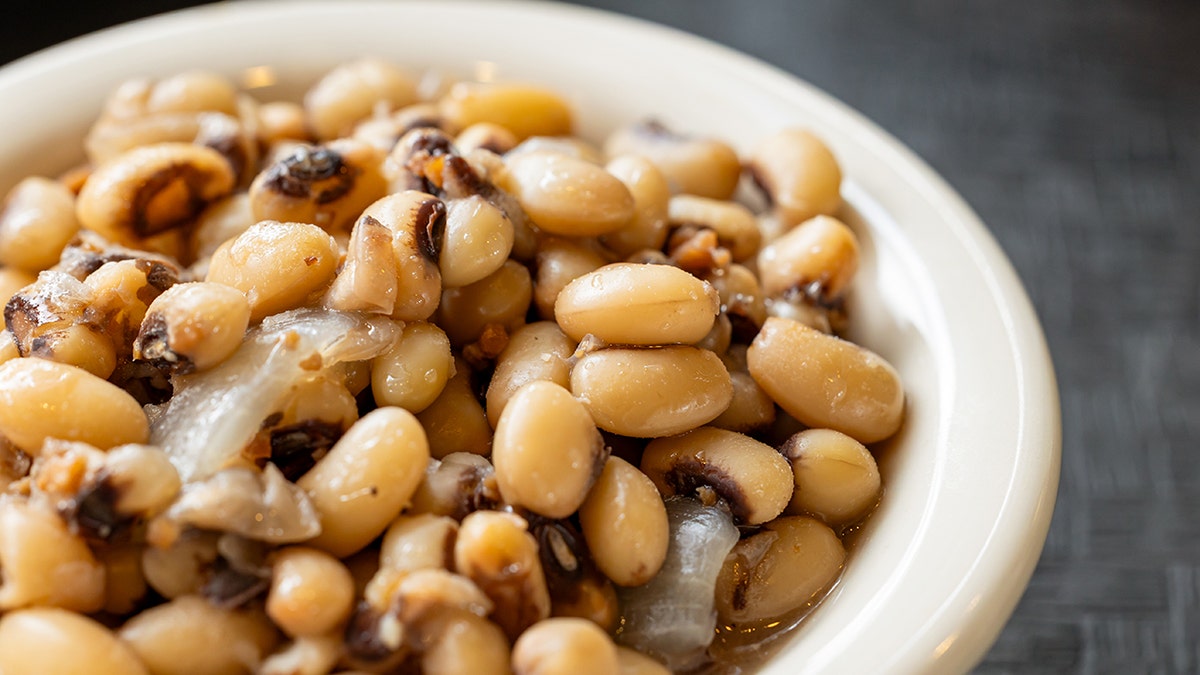 Cooked black-eyed peas are shown up close in a bowl.