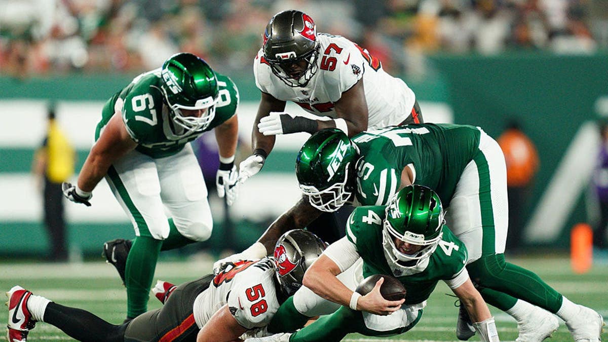 Brady Cook of the New York Jets is tackled by Jack Pyburn of the Tampa Bay Buccaneers at MetLife Stadium.