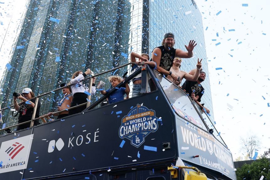 Los Angeles Dodgers players wave to the crowd during the World Series championship parade in downtown Los Angeles last year.