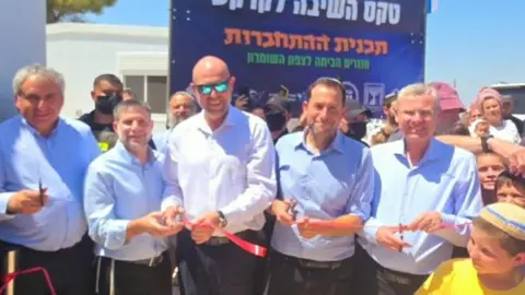 A group of men in shirts smiling and celebrating in the sunshine.