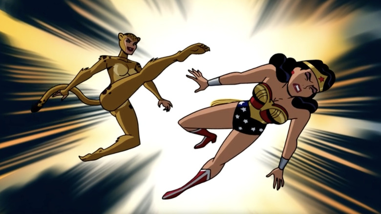 Cheetah kicking Wonder Woman. On the left, Cheetah is dressed in a full-body brown cheetah outfit, she also has a tail. On the right, Wonder Woman is dressed in a red, gold and blue outfit. There is a gold eagle design on her chest, and white stars on the bottom. She also has a gold tiara with a red star on it, as well as red boots with white detailing.