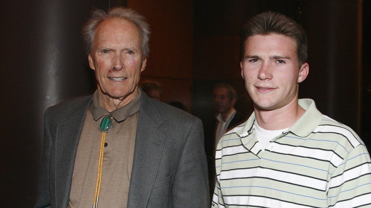 Clint Eastwood and his son Scott Eastwood smiling as they stood next to each other.