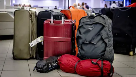 Getty Images Bags, suitcases and backpacks on the floor of an airport