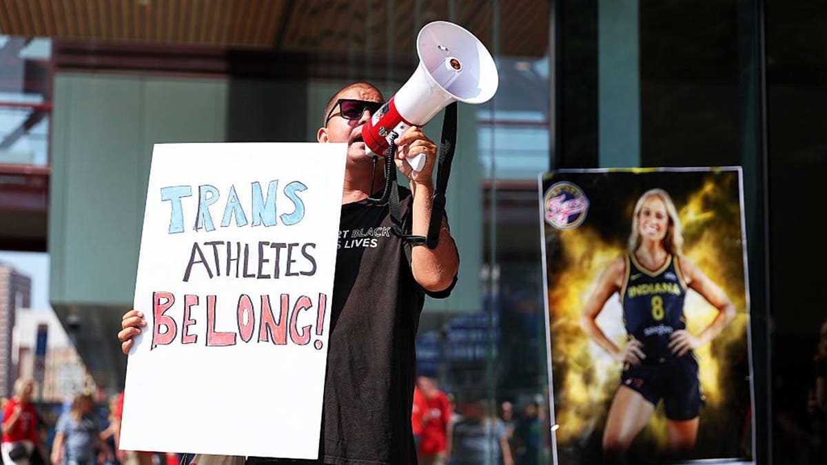 A demonstrator protests outside Target Center before a WNBA game between the Indiana Fever and Minnesota Lynx.