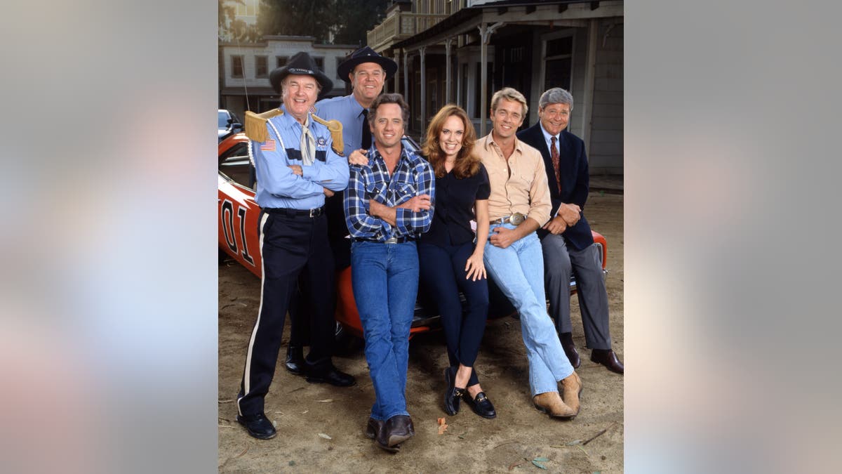 James Best, Rick Hurst, Tom Wopat, Catherine Bach, John Schneider and Ben Jones pose together as their Dukes of Hazzard characters.