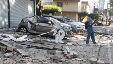 EPA Vehicles damaged by a collapsed wall are seen following an earthquake in Cali, Colombia, 10 August 2026.