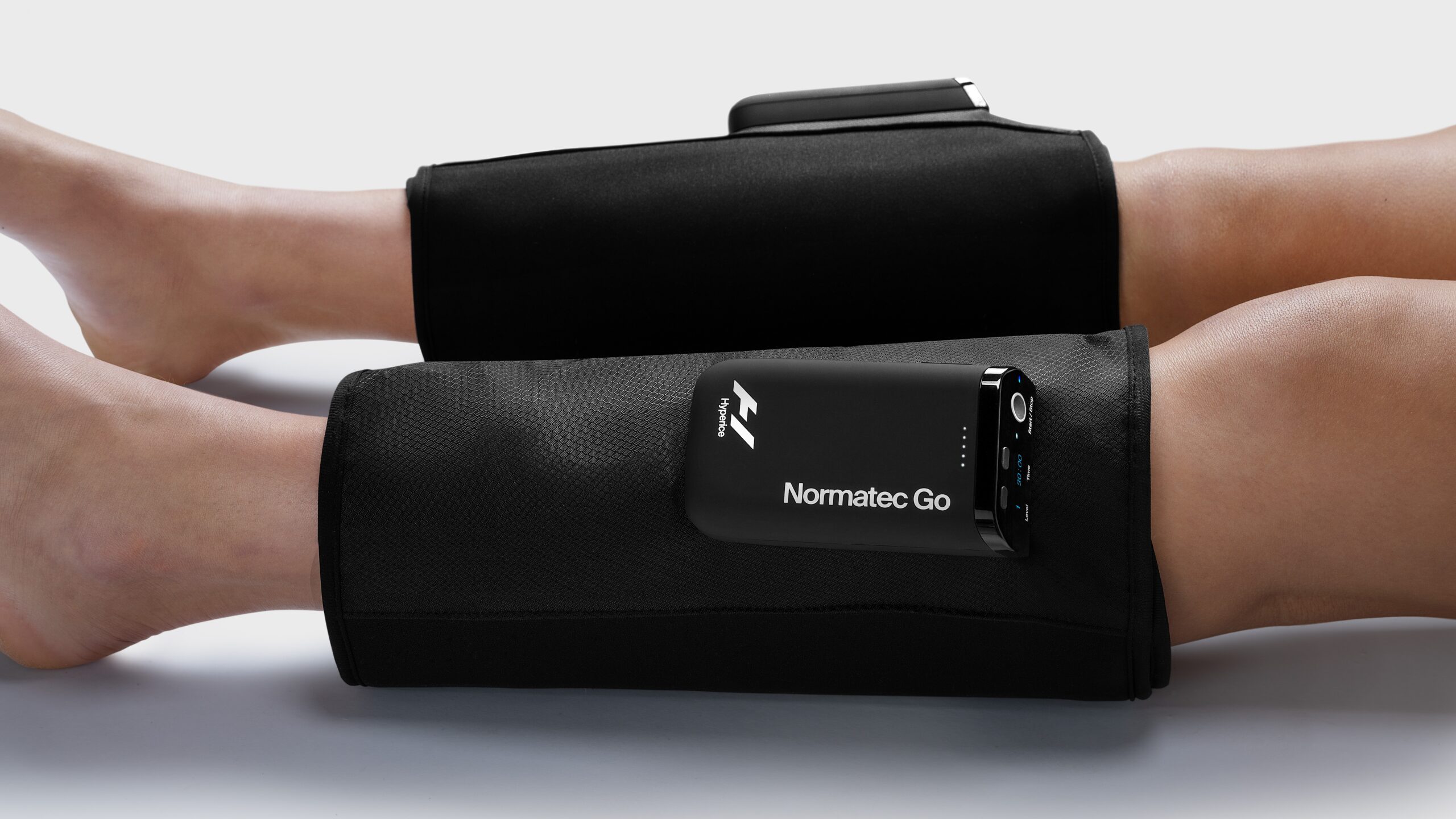 Normatec Go compression boots around a person's calves.