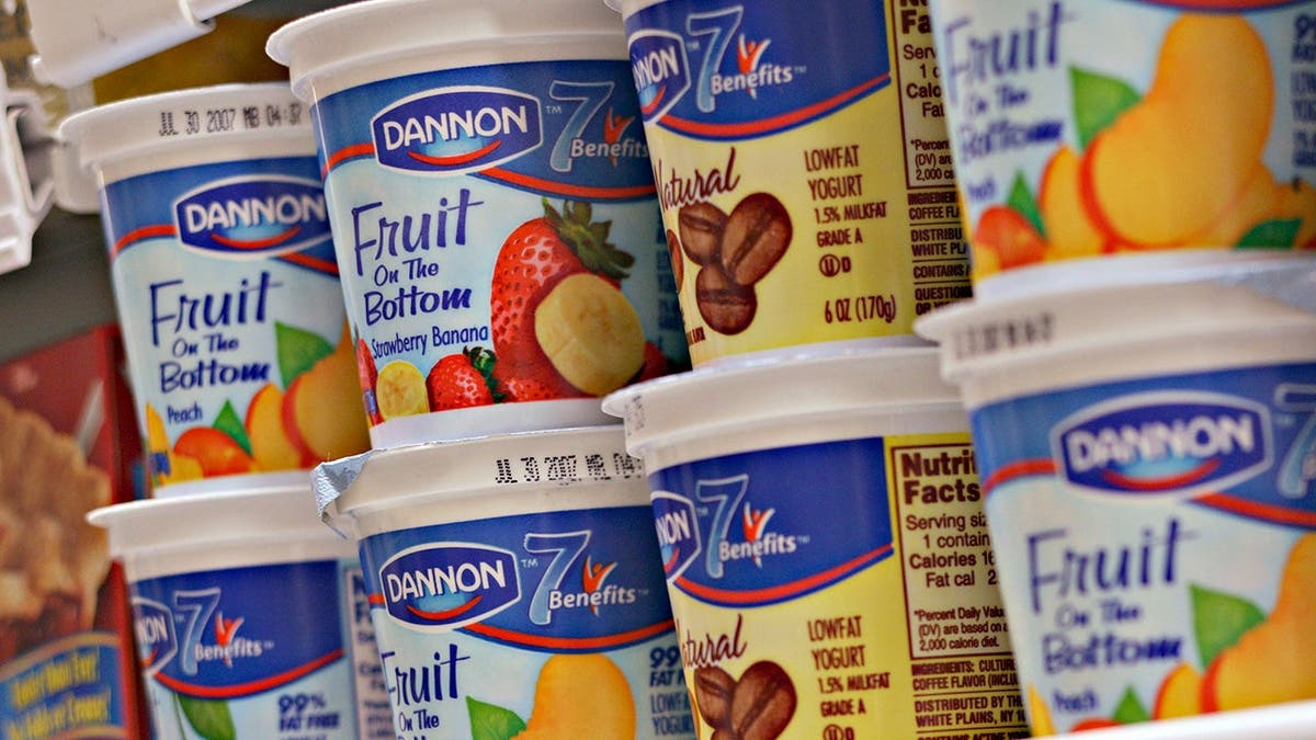A row of Dannon yogurt, included the coffee flavor, on a shelf.