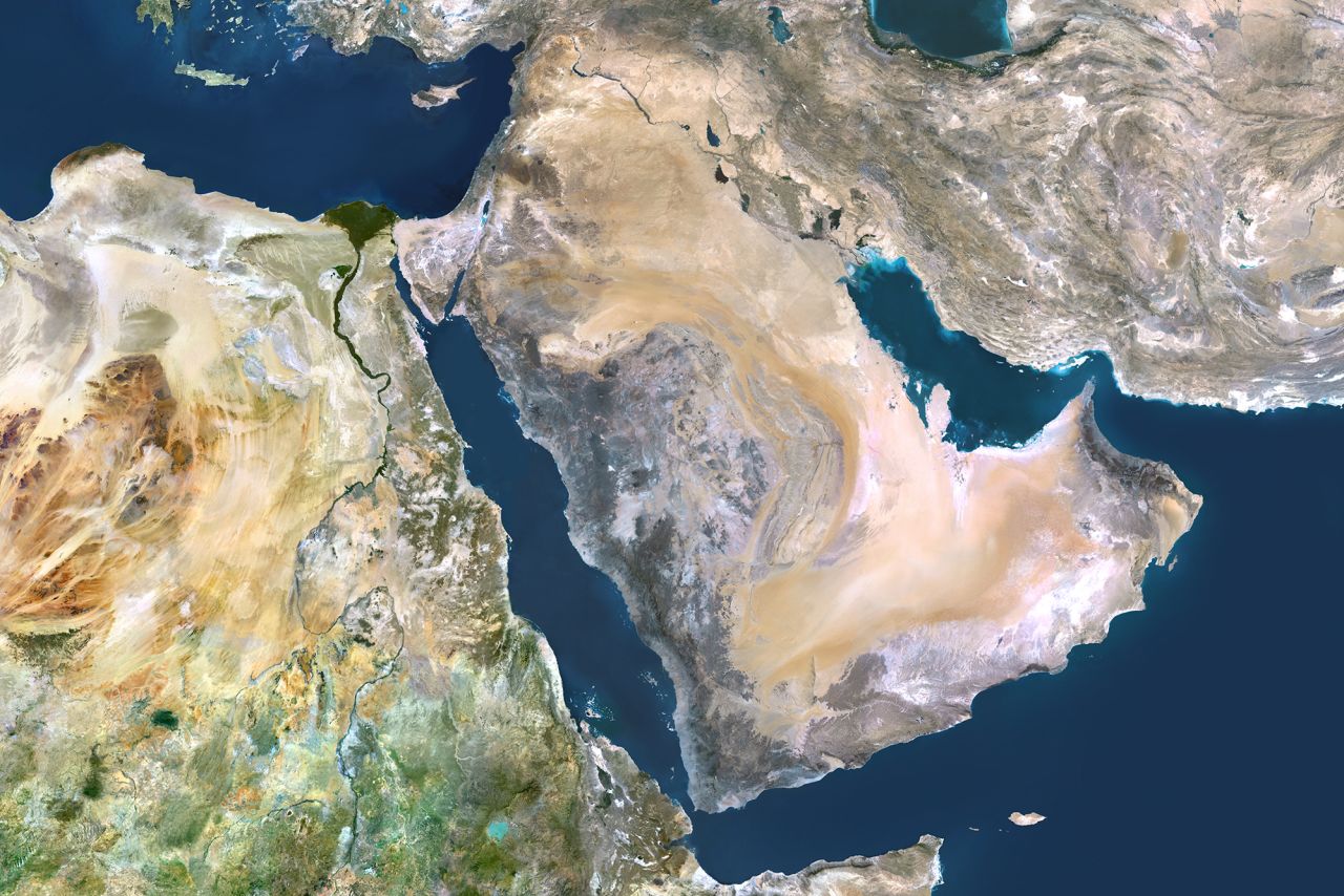 A satellite image shows the Arabian Peninsula with the Strait of Hormuz on the right and the Bab al-Mandeb at the center bottom of the map.