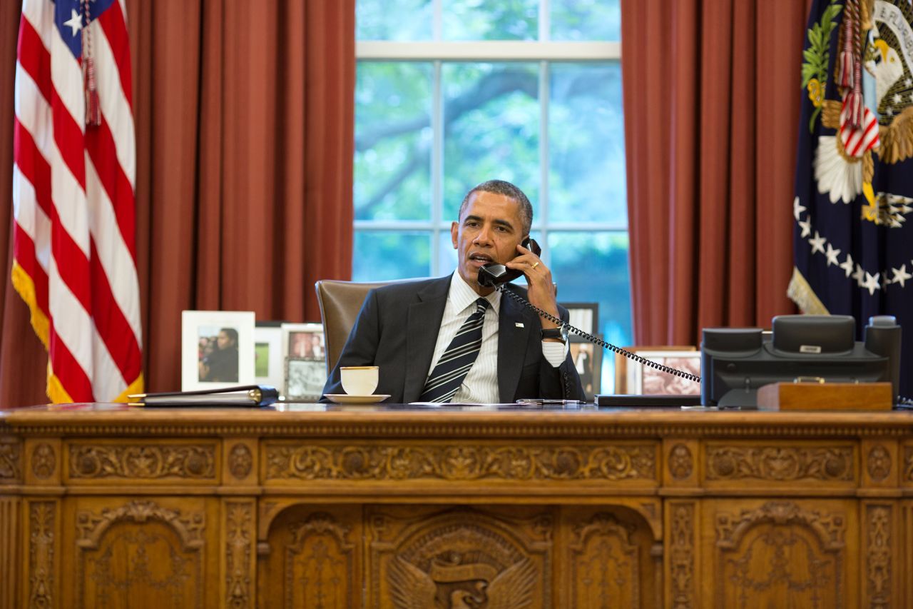 US President Barack Obama speaks with President Hassan Rouhani of Iran during a phone call in the Oval Office September 27, 2013.