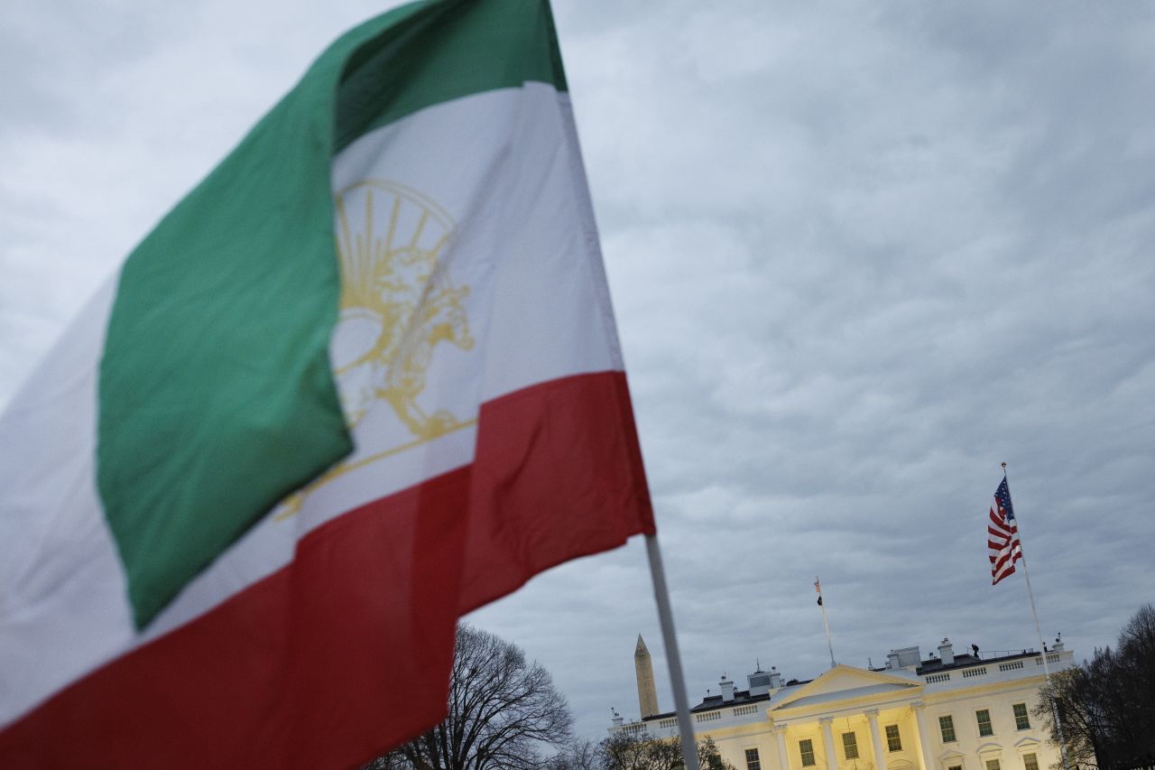 An Iranian flag flies near the White House, as Iranian Americans participate in a candlelight vigil on January 16, 2026 in Washington, DC. The vigil was held for the Iranians who died during the latest protests in Iran. Demonstrations began following the deadly government crackdown of protestors inside Iran. (Photo by Tom Brenner/Getty Images)