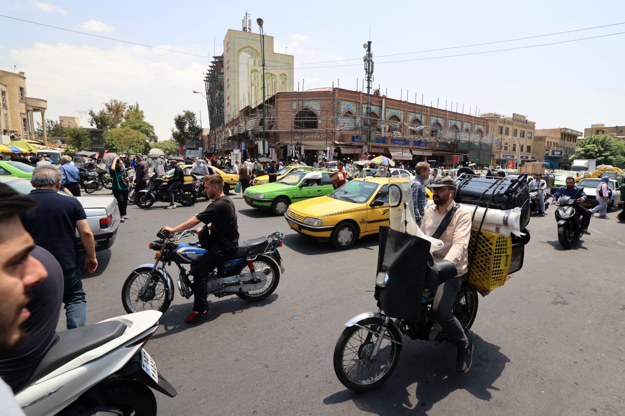 Traffic drives past the area of the Grand Bazaar in Tehran on Saturday.