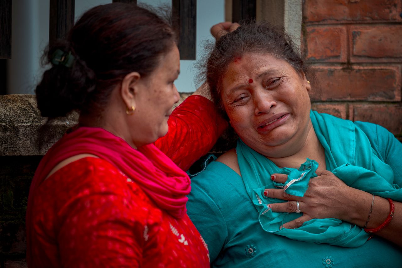 A woman cries outside Maharajgunj Medical Campus, where unidentified bodies recovered from the floods are being taken, in Kathmandu, Nepal on Saturday.