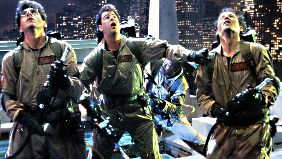 The cast of "Ghostbusters" looking stunned in costume.