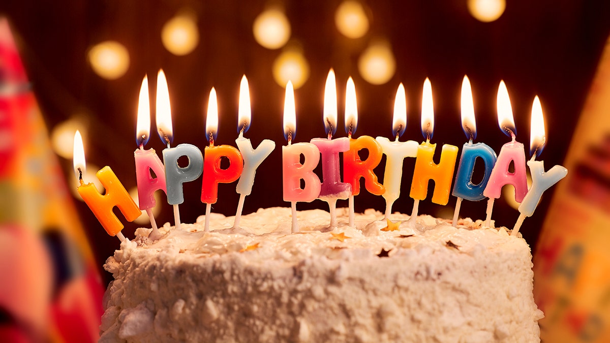 A cake with "happy birthday" spelled out in candles.